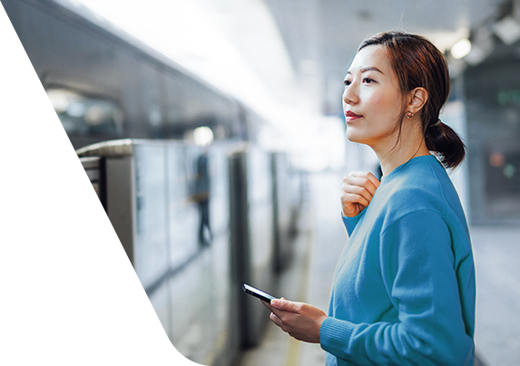 A woman standing confidently with a smartphone in her hand
